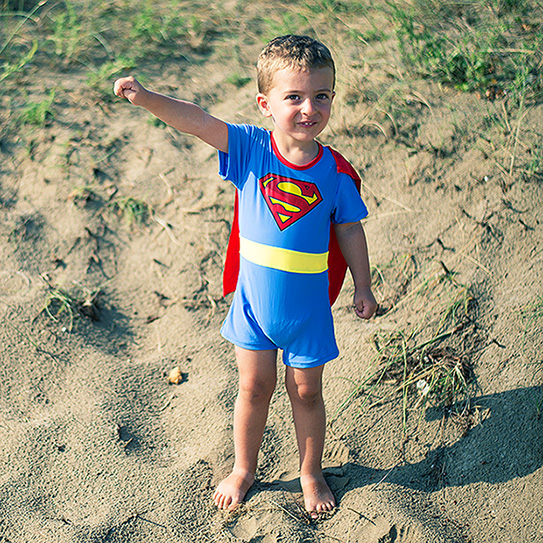 little boy with superman cape