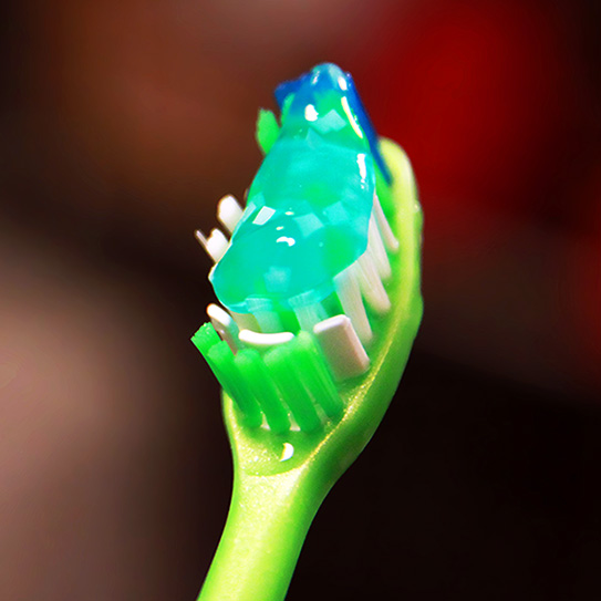 blue toothpaste on child's toothbrush