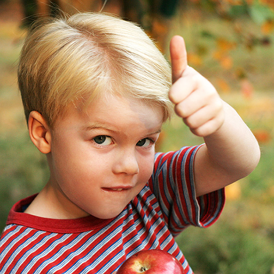 little boy giving a thumbs up