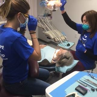 dentists giving cleaning to patient