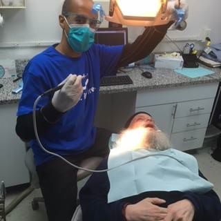 dentist shining light on patient