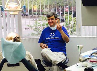 dentist smiling and giving peace sign