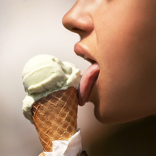 woman licking ice cream cone