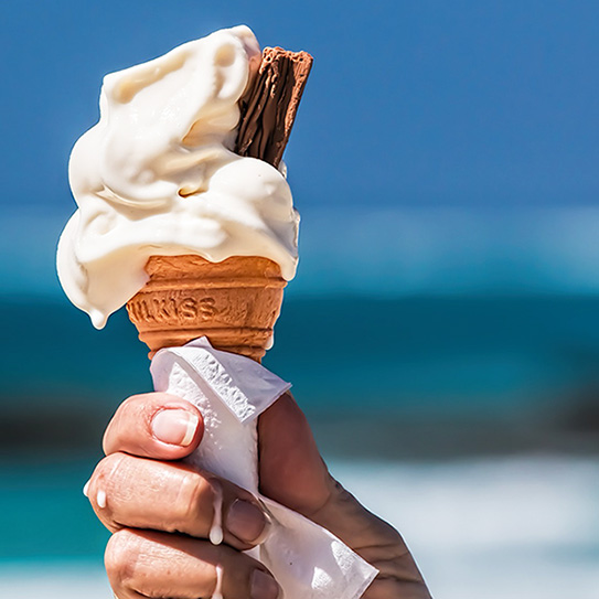 holding melted vanilla ice cream cone
