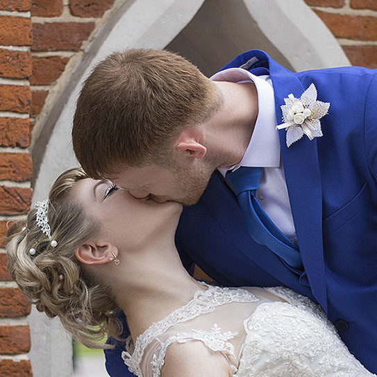 Newlyweds kissing at a wedding
