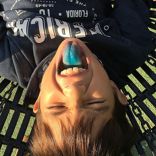 Young boy showing blue tongue