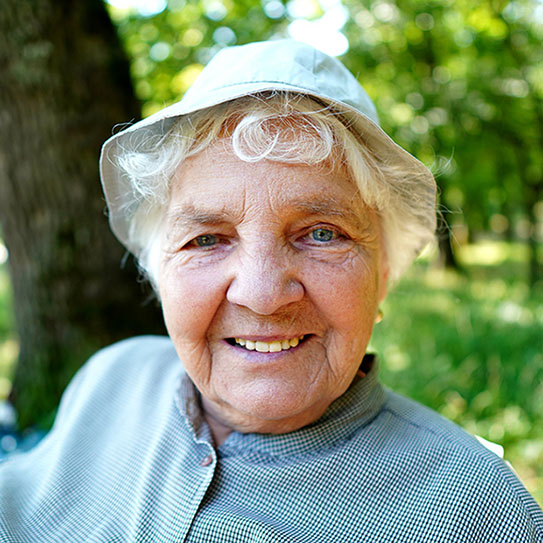 Older woman with a hat on smiling