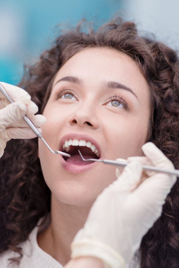 Woman having teeth examined at dentists - dentist Appointment