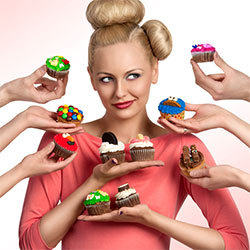 blonde woman surrounded by hands holding cupcakes