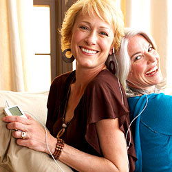 two middle aged woman listening to music