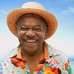 65 year old man in tropical vacation attire smiling