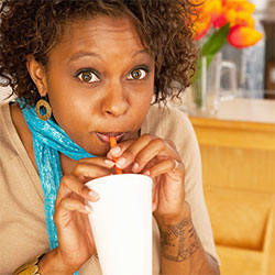 woman drinking out of a straw