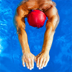 man swimming in a swim cap